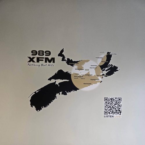 Wall graphic featuring a map of Nova Scotia and Prince Edward Island for 989 XFM, showing broadcast coverage areas with station logo and QR code to listen live.