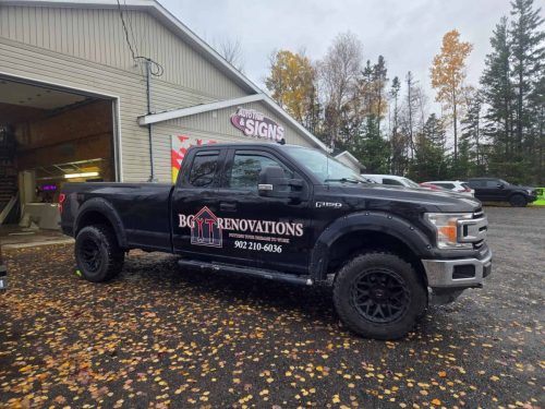 Black Ford F-150 truck with a BG Renovations logo and contact number displayed on the door, parked outside Auto Trim  Signs in New Glasgow.