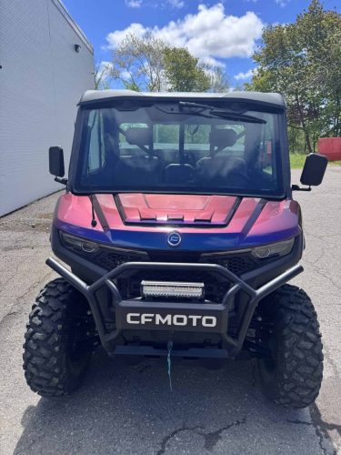 Front view of a wrapped CFMOTO side-by-side ATV with colour-shifting blue and purple vinyl.