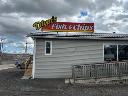 Dina's fish and chips sign on the shop