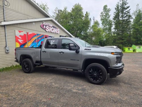 Branded Chevy Silverado 2500 HD with custom door and unit number decals