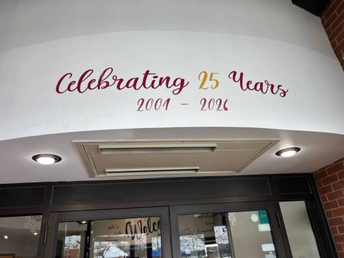 Interior entrance signage at Glasgow Square Theatre reading Celebrating 25 Years 2001 to 2026 above the main doors.