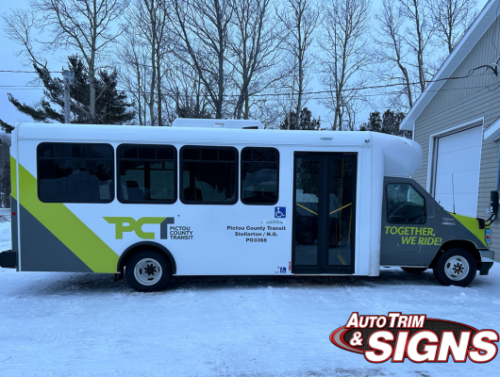 Image of a Pictou County Transit bus parked in a snowy lot, featuring a fresh, custom wrap with 'PCT' in large block letters and a dynamic teal and lime green design. The slogan 'Together, We Ride' is displayed on the rear side panel, emphasizing community and connectivity.