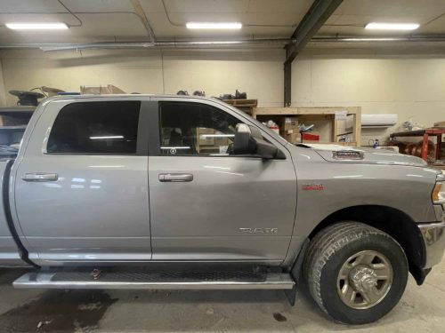 Grey RAM truck with no business branding or decals on the door