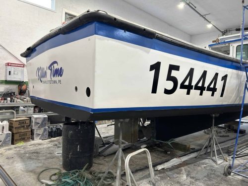Boat registration numbers and “Killin Time” name decal on rear of fishing boat