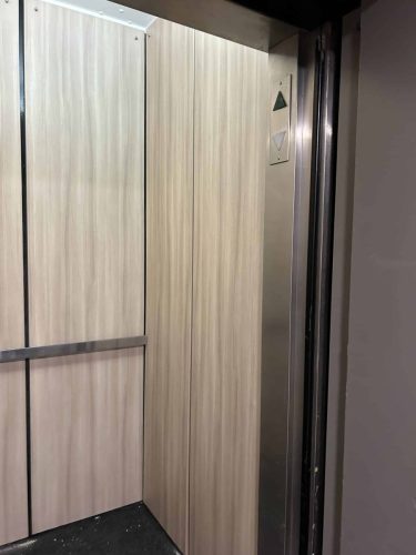 elevator-wrap-woodgrain-panels-door-open