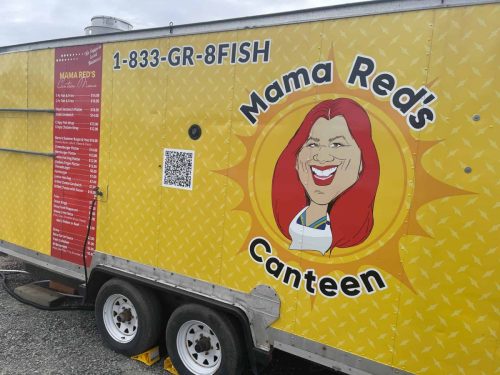 Close-up of the side of Mama Red’s Canteen food truck with the full menu on the left and large illustrated logo on a yellow diamond-plate patterned background.
