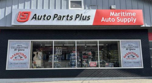 Maritime Auto Supply storefront with Auto Parts Plus signage and window graphics celebrating 90 years