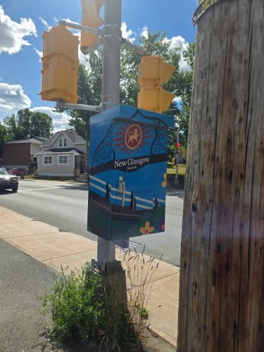 Decorative traffic box art in New Glasgow with a colorful design highlighting local icons and community spirit.