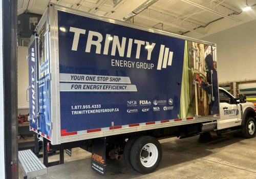 Box truck wrap for Trinity Energy Group featuring bold blue branding, company information, and energy efficiency messaging